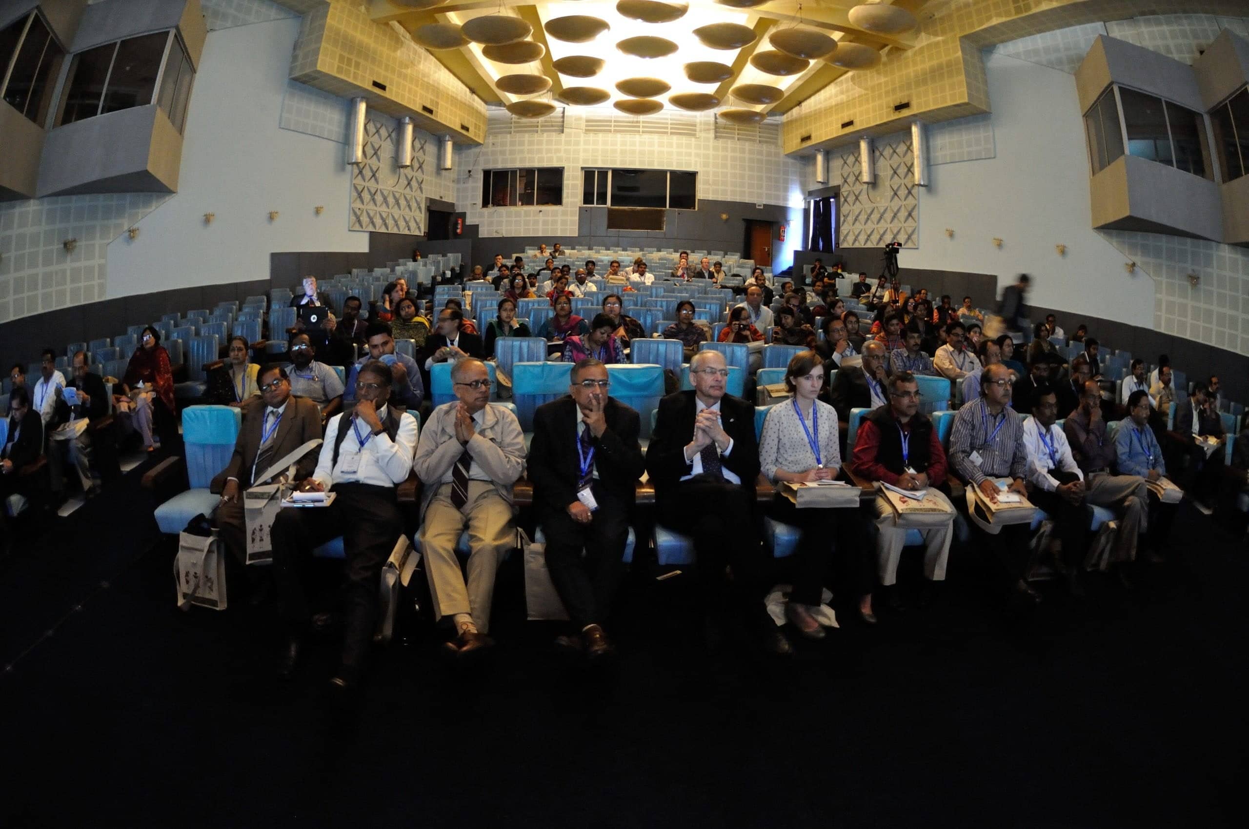 Delegates seated in a large conference hall.