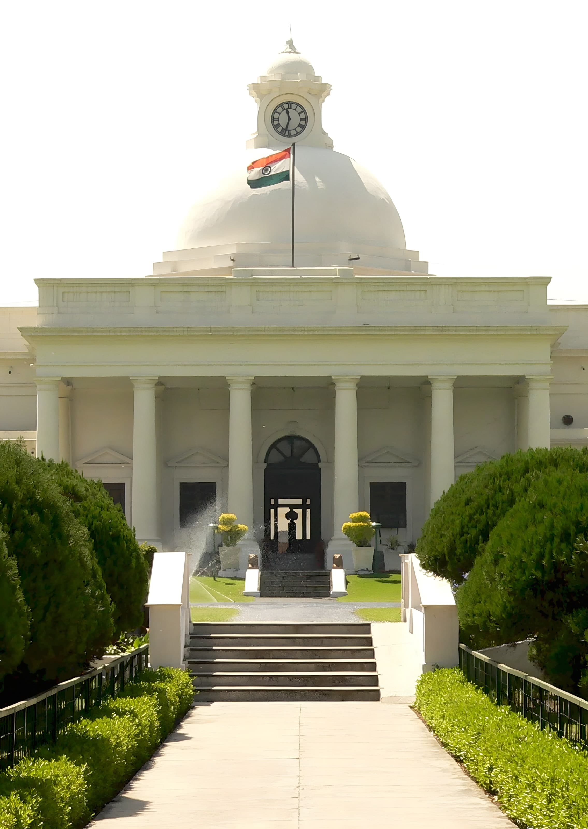 The Main Building of IIT Roorkee: a white dome and clock above its colonnade, with the national flag flying.